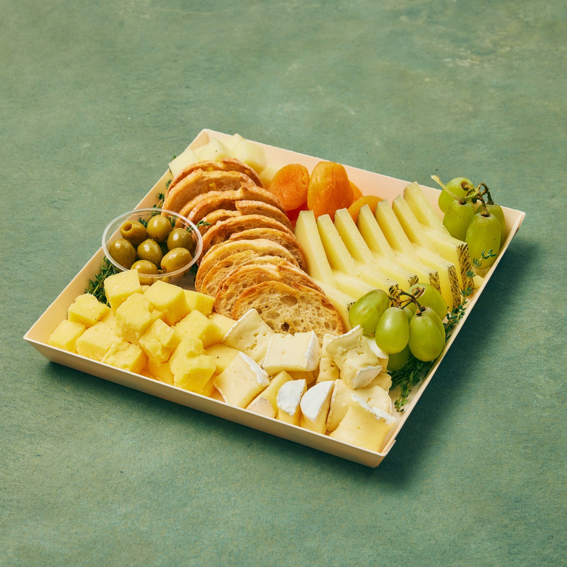 Selection of cheeses, fruits, and crostini